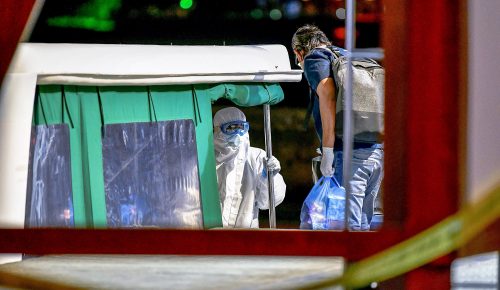 A health official (L) transfers a positive patient of COVID-19 coronavirus on a speed boat to an isolation facility from the capital city Male early on May 1, 2020. - The Maldives reported its first coronavirus fatality on April 30 with the death of an 83-year-old woman, as the Indian Ocean holiday hotspot extended a nationwide lockdown. (Photo by Ahmed SHURAU / AFP) (Photo by AHMED SHURAU/AFP via Getty Images)